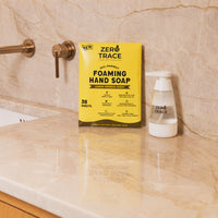 An eco-friendly bathroom sink with a bottle of Zero Trace Hand Soap Sheets next to it.