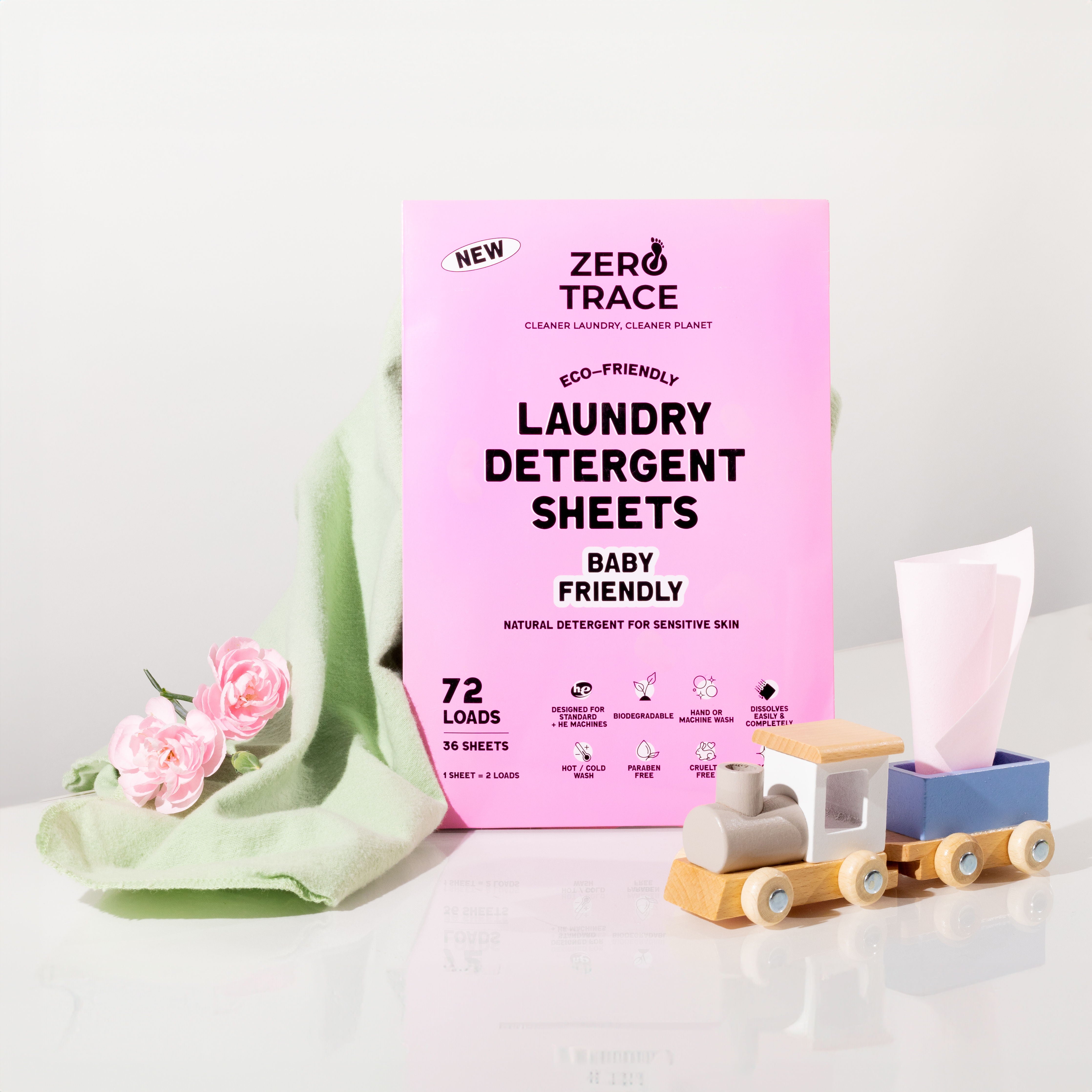 Zero Trace laundry detergent sheets in a pink box next to a wooden toy.