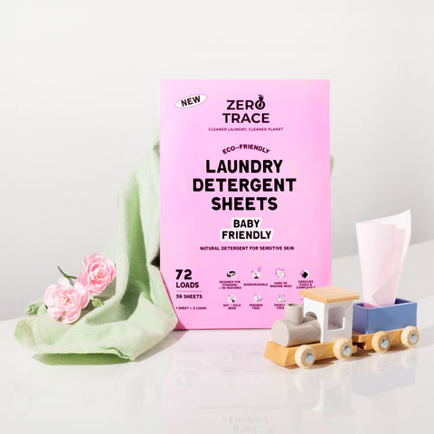 Zero Trace laundry detergent sheets in a pink box next to a wooden toy.